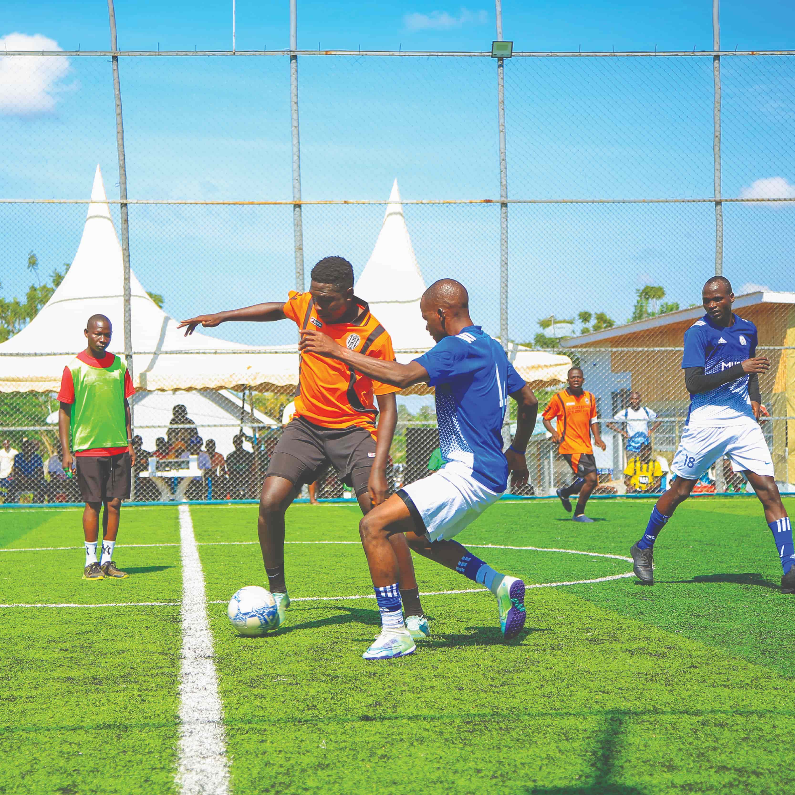 Image of players playing soccer on artificial turf